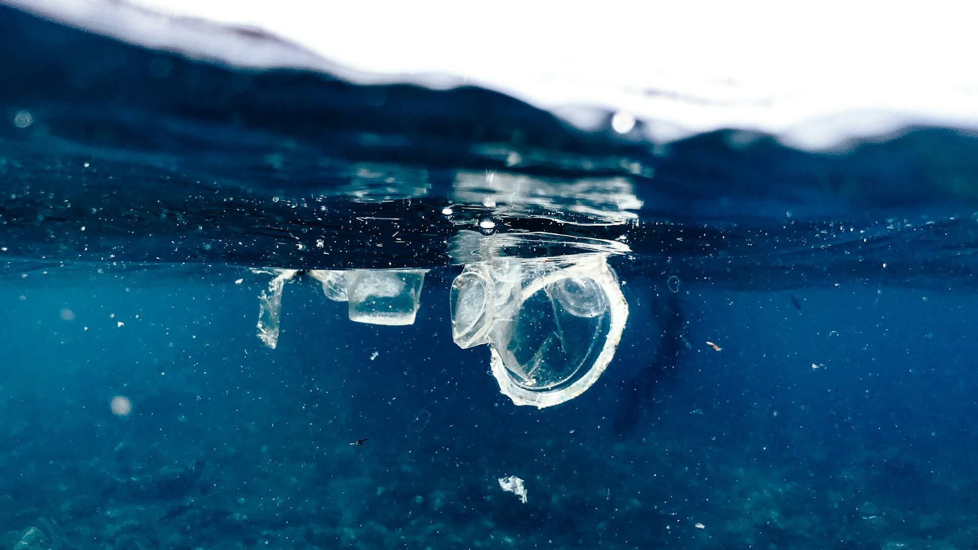 A piece of plastic in the ocean, showing why reducing waste while travelling is essential.